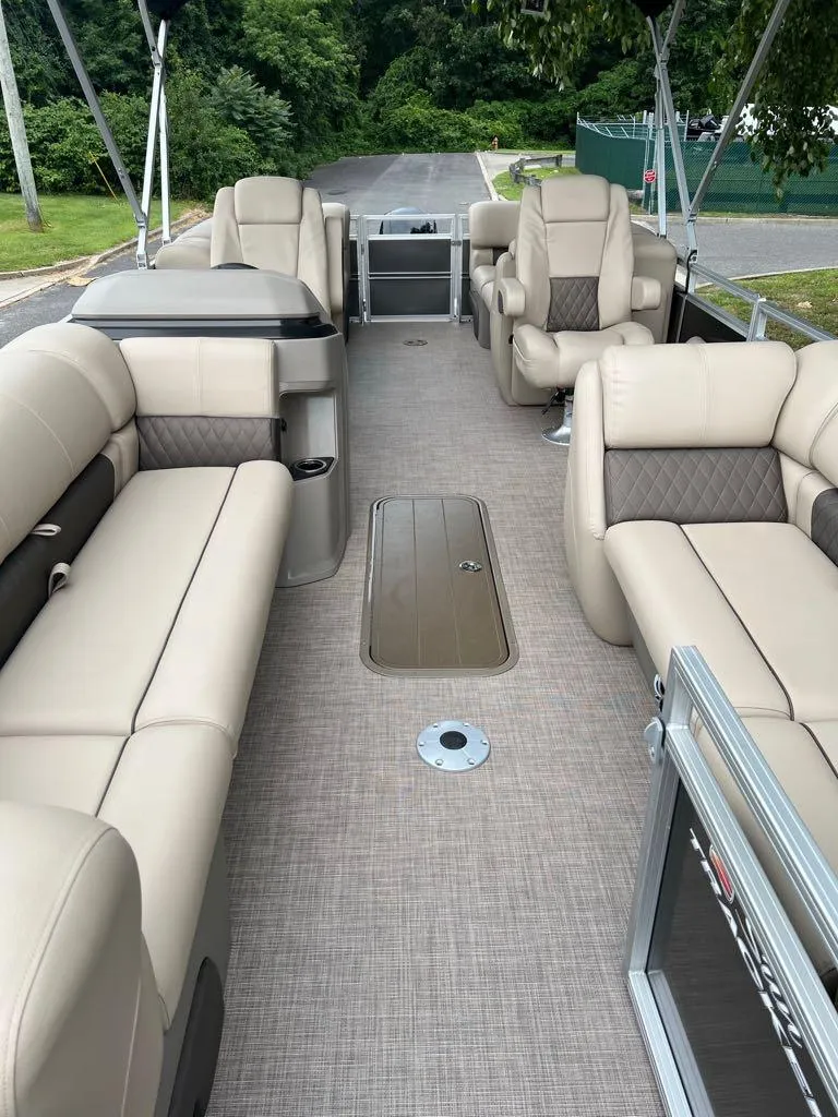 Slide: The Image of 2024 Sun Tracker Party Barge 22 XP3 interior with beige seating and spacious layout. - 4