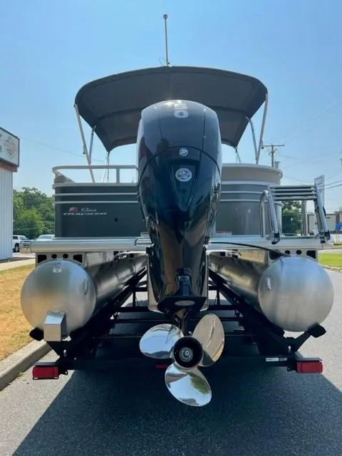 Slide: The Image of 2024 Sun Tracker Party Barge 22 XP3 pontoon boat rear view with outboard motor. - 8
