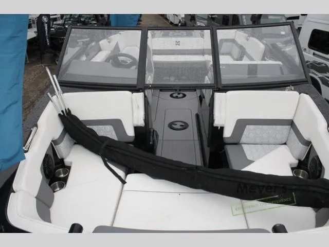 Slide: The Image of 2024 Heyday H20 boat interior with white and gray seating, windshield, and cup holders. - 7