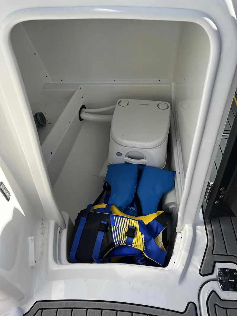Slide: The Image of 2022 Monterey M-45 boat interior with portable toilet and life jackets. - 12