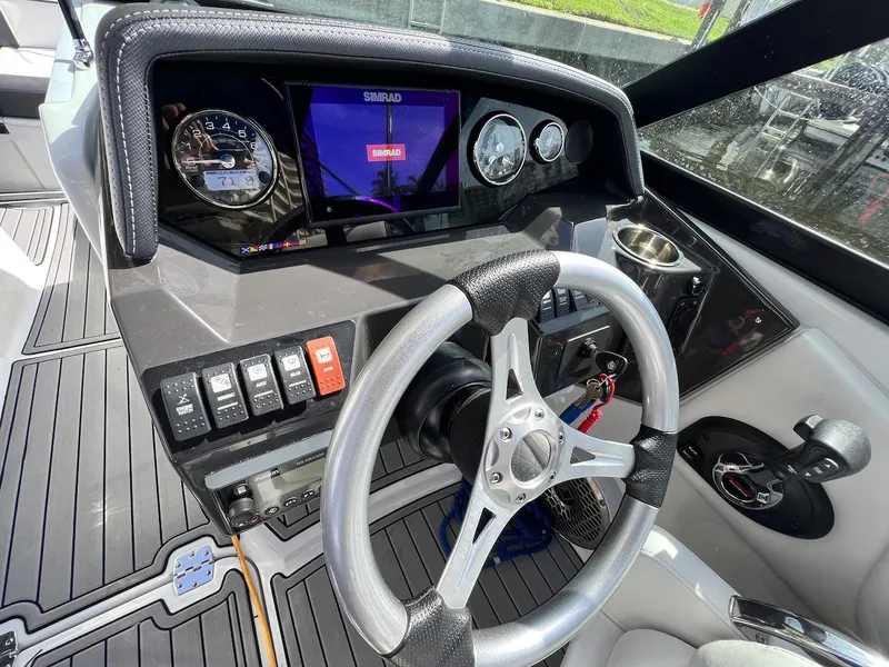 Slide: The Image of Cockpit of 2022 Monterey M-45 boat with steering wheel, gauges, and control panel. - 28