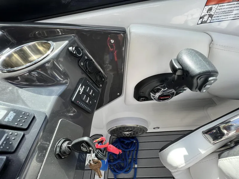 Slide: The Image of 2022 Monterey M-45 boat cockpit with control panel, steering wheel, and ignition keys. - 29