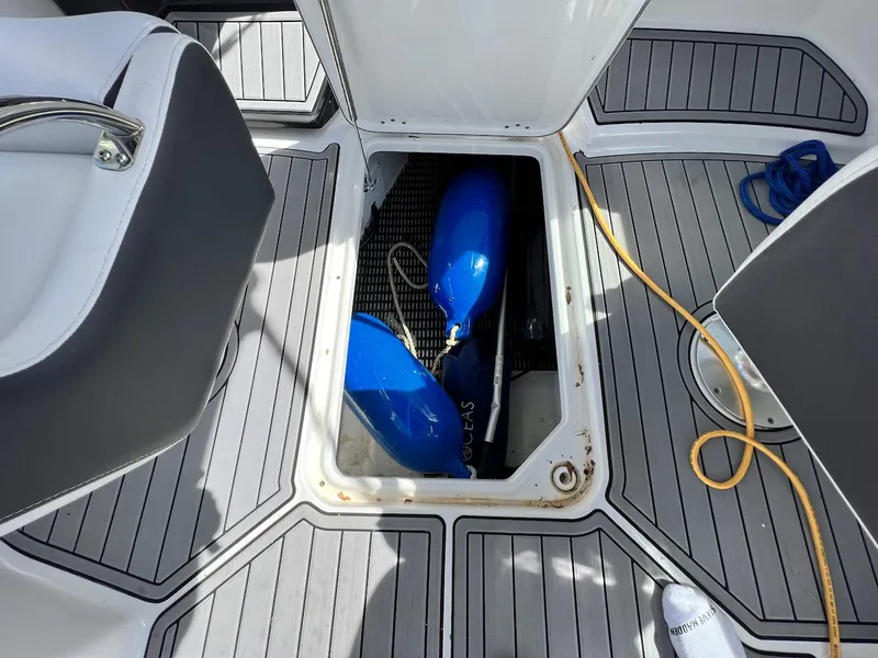Slide: The Image of Storage compartment on a 2022 Monterey M-45 boat with blue fenders and yellow cord. - 32