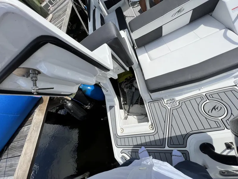 Slide: The Image of 2022 Monterey M-45 boat interior with seating and deck details at a dock. - 34