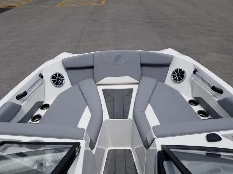 Slide: The Image of 2023 ATX Surf Boats 20 Type-S bow seating area with gray upholstery and built-in speakers. - 17
