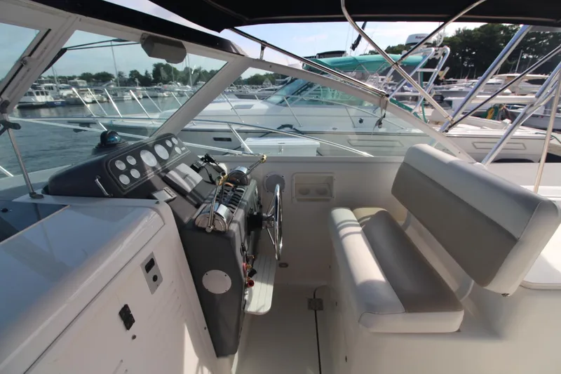 Slide: The Image of 2001 Tiara Yachts 2900 Coronet cockpit with helm, seating, and marina view. - 10