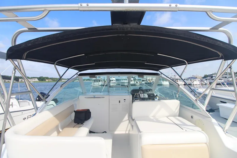 Slide: The Image of 2001 Tiara Yachts 2900 Coronet with black canopy, docked in a marina. - 12