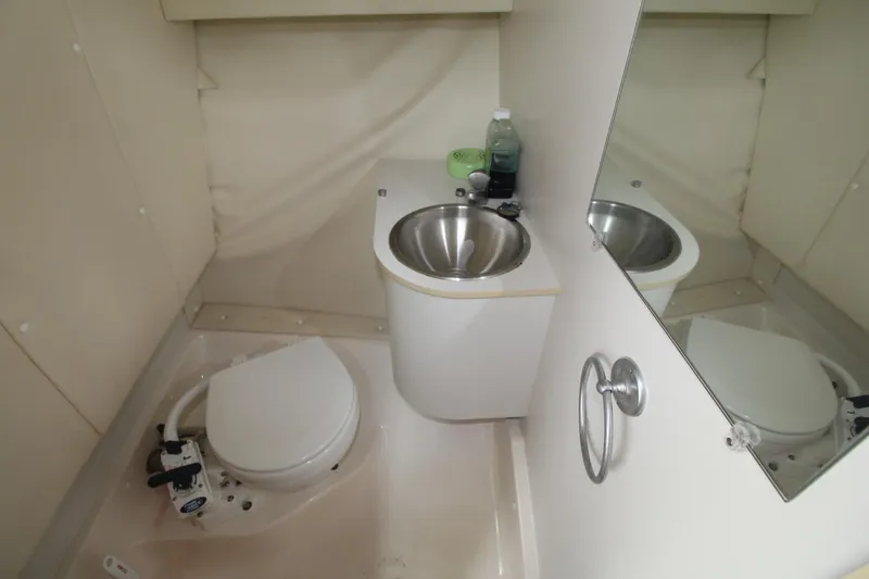 Slide: The Image of Compact bathroom in 2001 Tiara Yachts 2900 Coronet with toilet and stainless steel sink. - 16