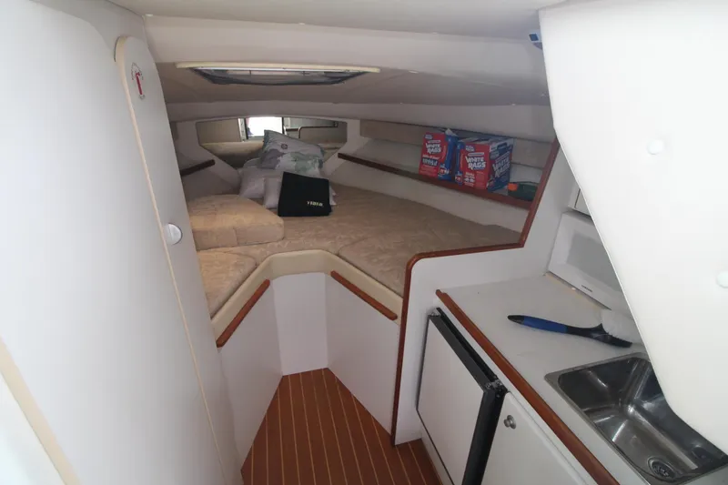 Slide: The Image of 2001 Tiara Yachts 2900 Coronet cabin interior with kitchenette and sleeping area. - 17
