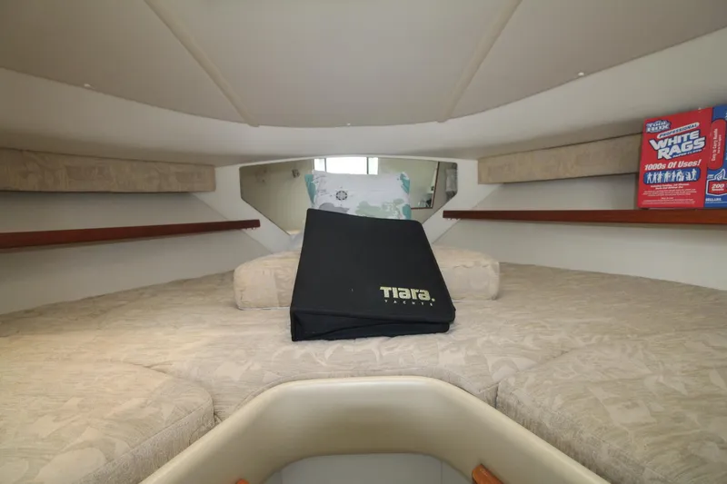 Slide: The Image of 2001 Tiara Yachts 2900 Coronet cabin interior with cozy bedding and storage. - 19