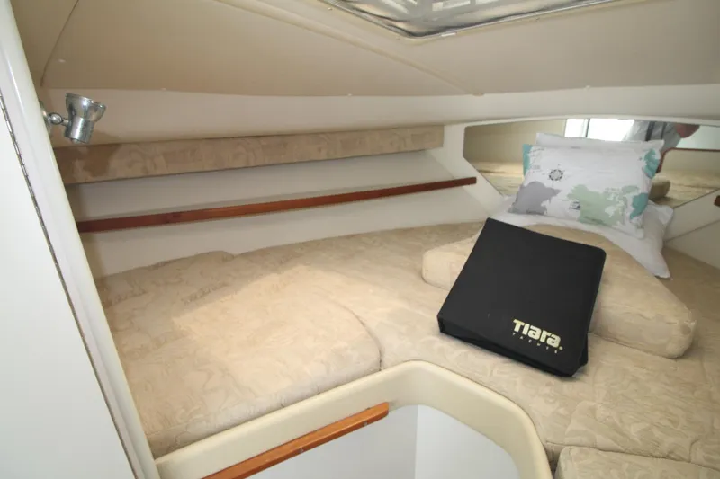 Slide: The Image of 2001 Tiara Yachts 2900 Coronet cabin interior with beige bedding and pillows. - 20