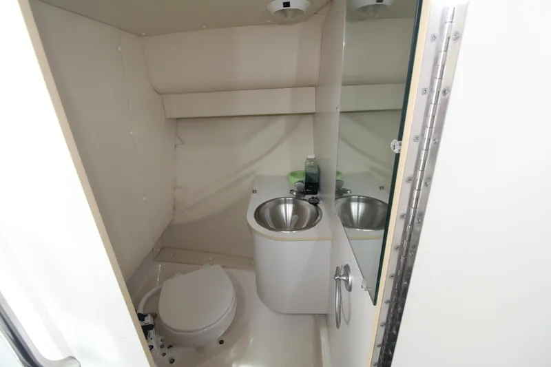 Slide: The Image of 2001 Tiara Yachts 2900 Coronet bathroom with toilet, sink, and mirror. - 27