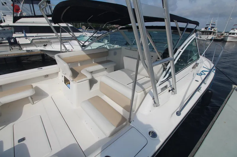 Slide: The Image of 2001 Tiara Yachts 2900 Coronet with spacious seating, docked at a marina. - 4