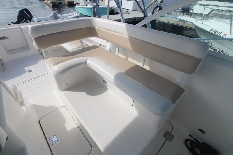 Slide: The Image of 2001 Tiara Yachts 2900 Coronet interior seating area with beige cushions and white deck. - 8