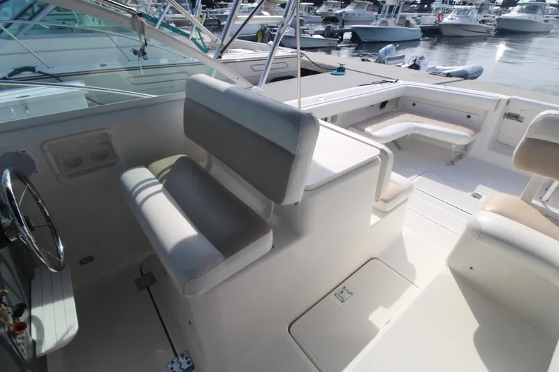 Slide: The Image of 2001 Tiara Yachts 2900 Coronet interior with seating and helm, docked at marina. - 9