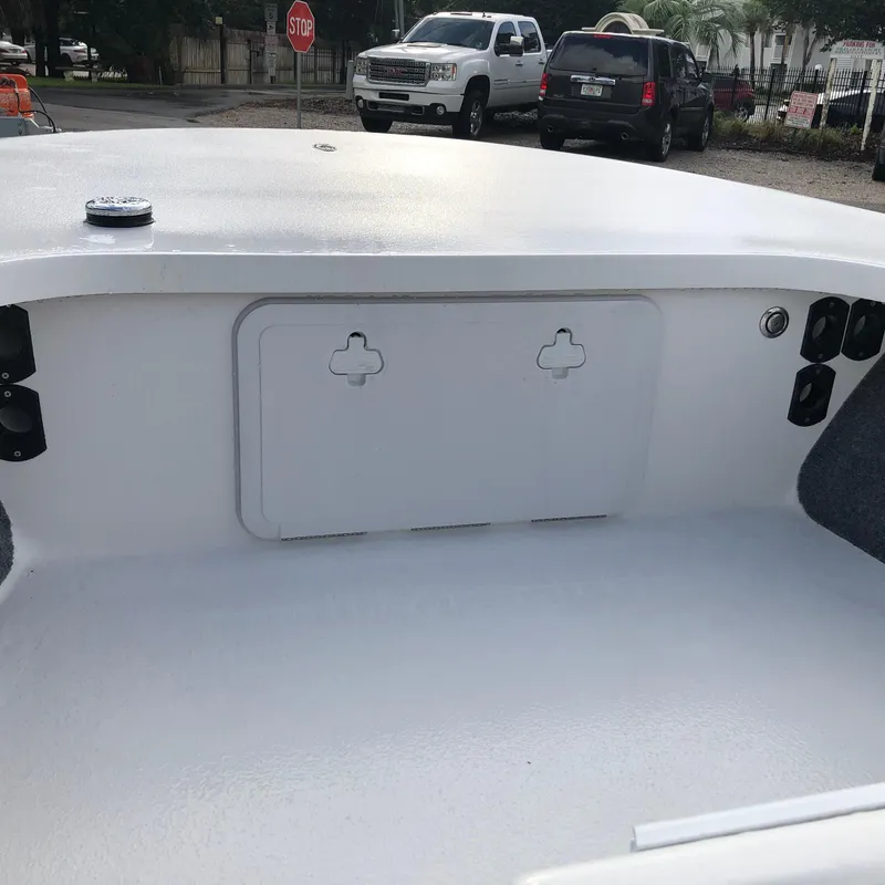 Slide: The Image of 2025 Mitzi Skiffs 17 boat interior with storage compartment and clean white finish. - 12