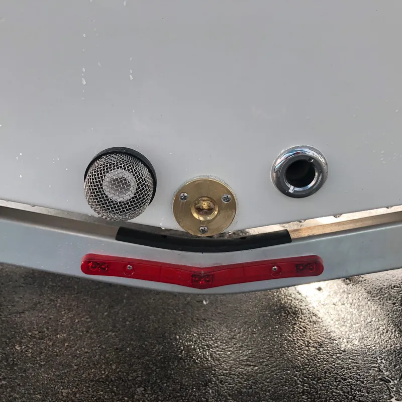 Slide: The Image of Close-up of a 2025 Mitzi Skiffs 17 boat's stern fittings and trailer lights. - 13