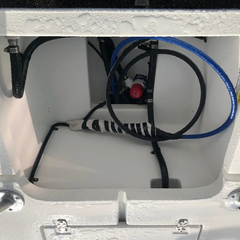 Slide: The Image of Interior view of 2025 Mitzi Skiffs 17 boat compartment with hoses and wiring. - 14