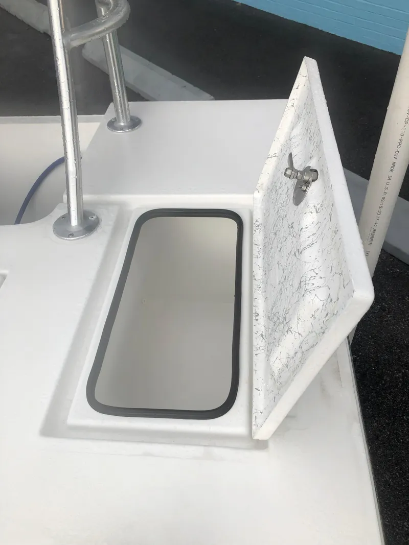 Slide: The Image of 2025 Mitzi Skiffs 17 boat storage compartment with open hatch. - 16