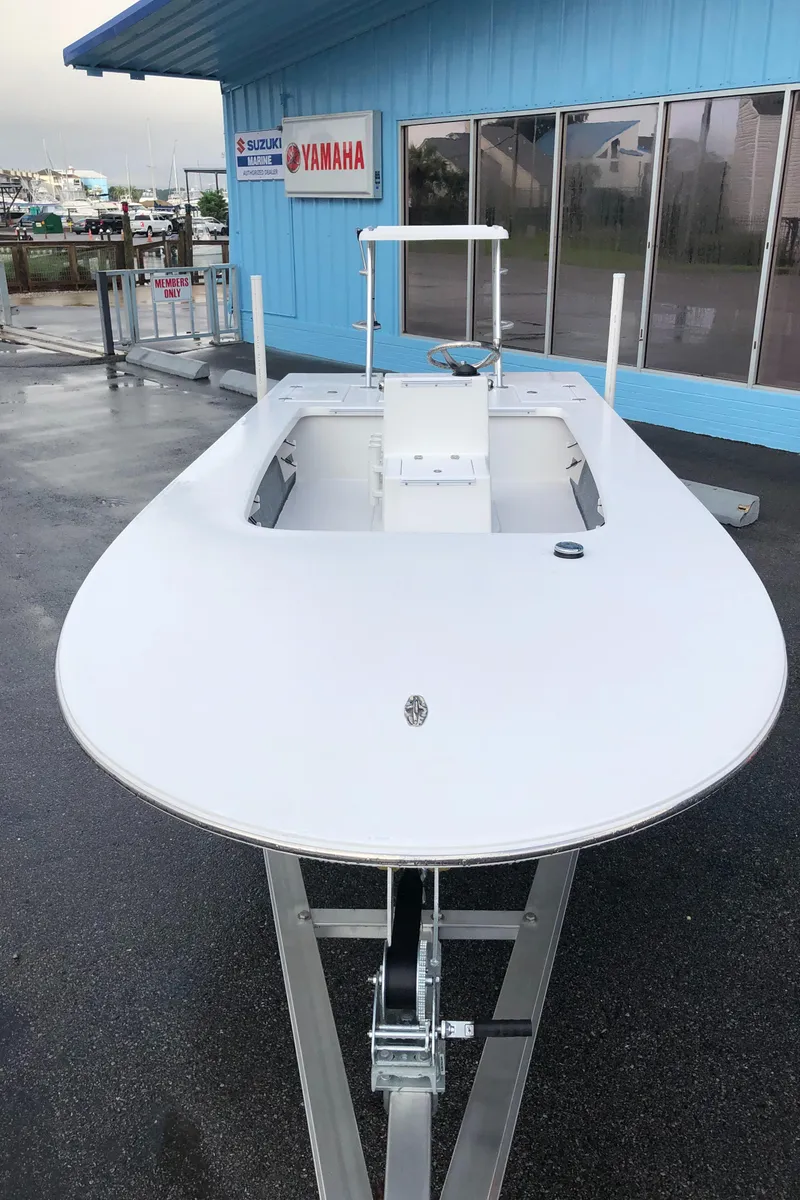 Slide: The Image of 2025 Mitzi Skiffs 17 boat displayed outside a Yamaha dealership. - 17