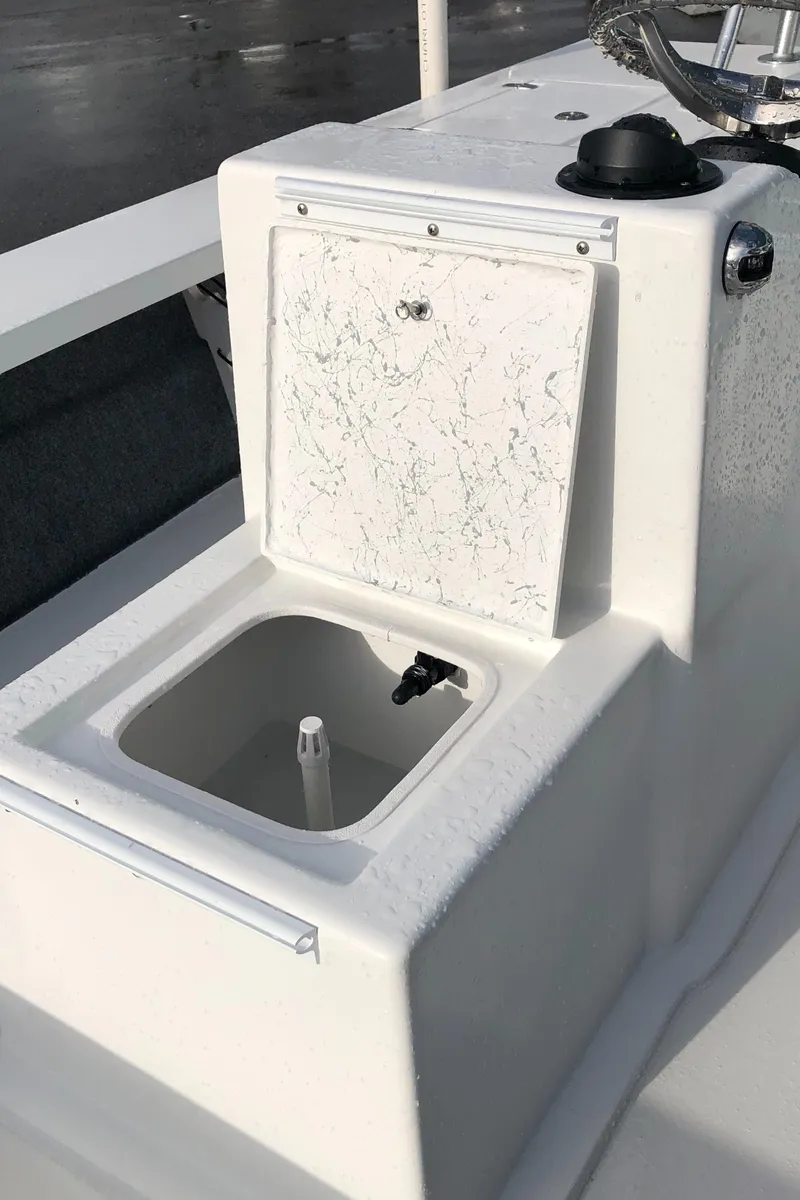 Slide: The Image of 2025 Mitzi Skiffs 17 boat console with storage compartment and control panel. - 19