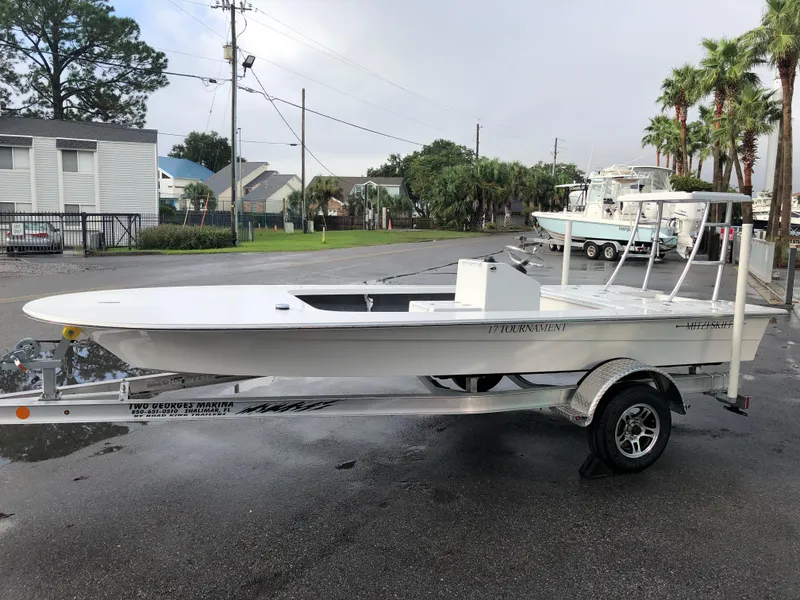 Slide: The Image of 2025 Mitzi Skiffs 17 on trailer, parked outdoors, ready for fishing adventures. - 2
