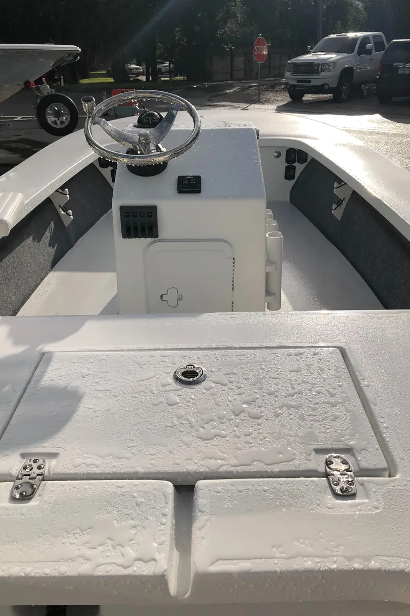 Slide: The Image of 2025 Mitzi Skiffs 17 boat interior with steering console and storage compartments. - 25