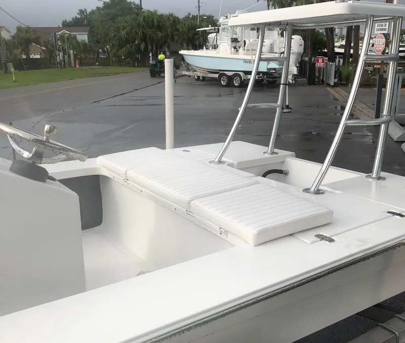 Slide: The Image of 2025 Mitzi Skiffs 17 boat with white seating and sleek design. - 26