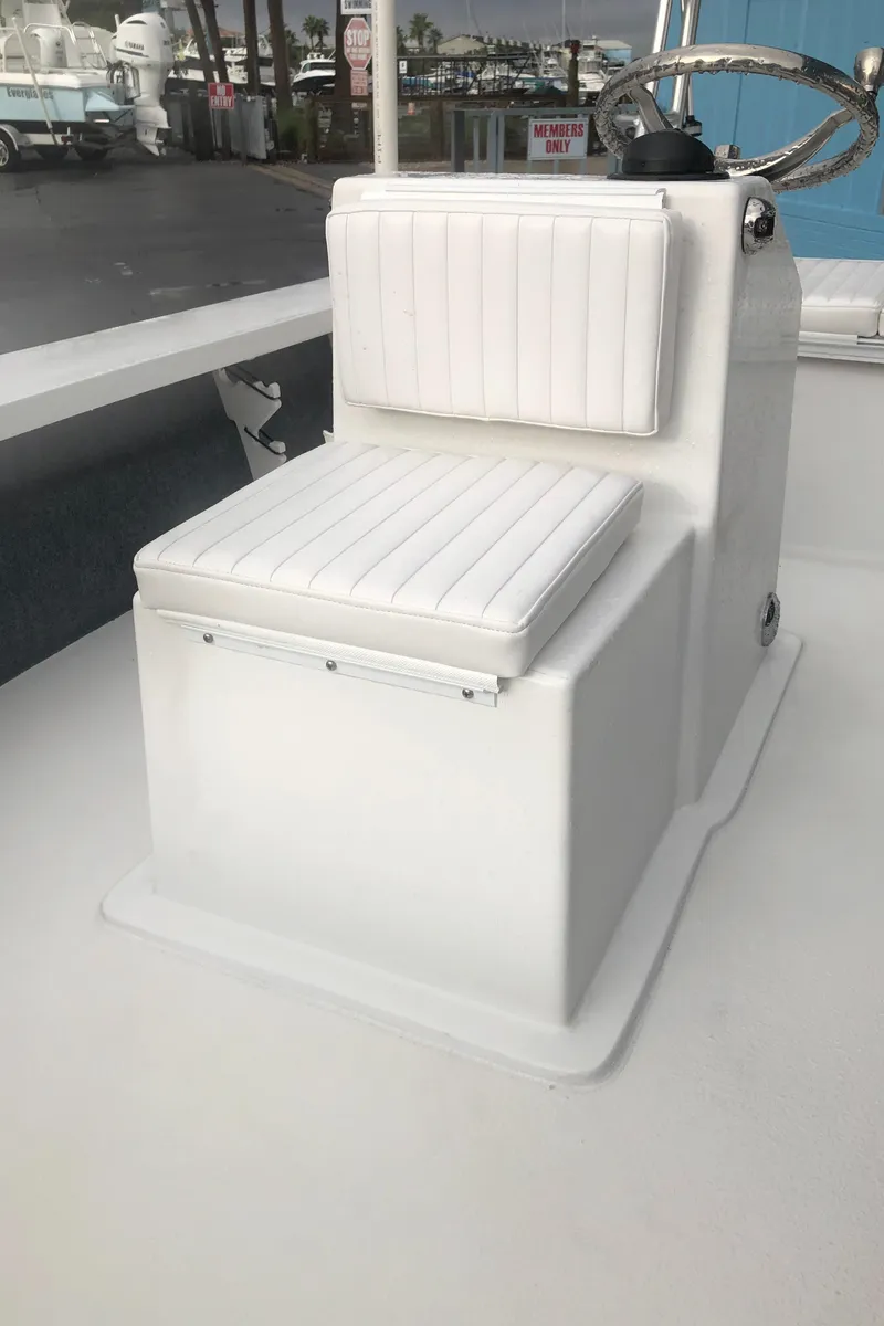Slide: The Image of 2025 Mitzi Skiffs 17 boat seat with white cushioned upholstery. - 27