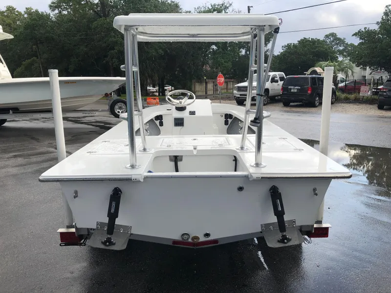 Slide: The Image of 2025 Mitzi Skiffs 17 boat, rear view, parked outdoors on wet pavement. - 4