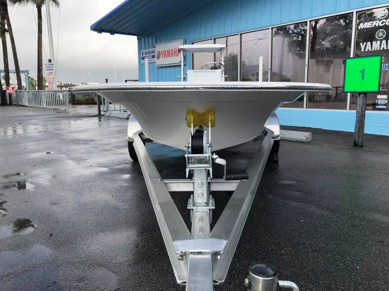 Slide: The Image of 2025 Mitzi Skiffs 17 boat on trailer at dealership, overcast day. - 8