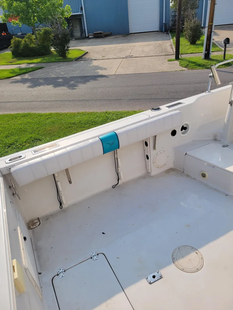 Slide: The Image of 1996 Pro-Line 231 Walk Around Cuddy boat interior, spacious deck area. - 10