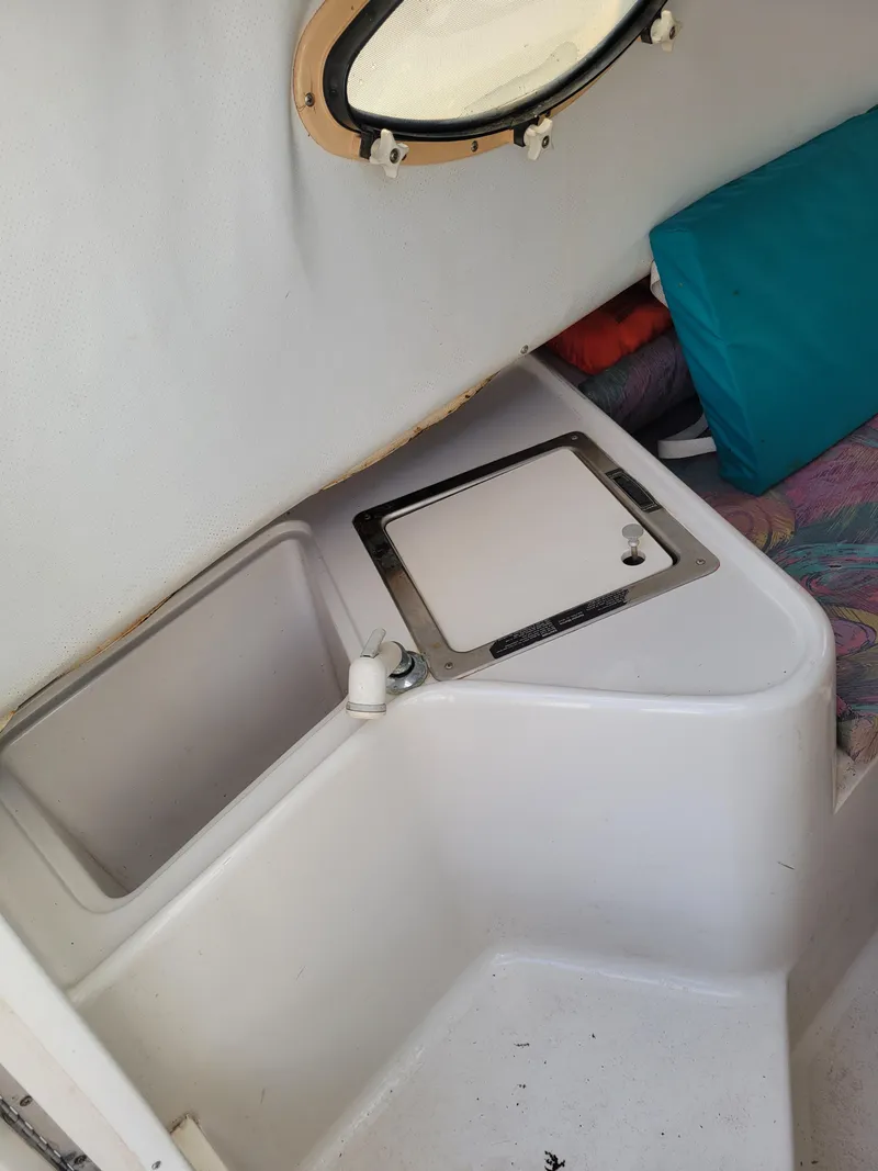 Slide: The Image of 1996 Pro-Line 231 Walk Around Cuddy cabin interior with storage compartment. - 11