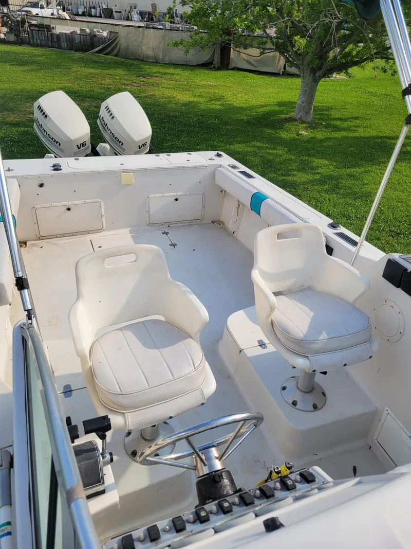 Slide: The Image of 1996 Pro-Line 231 Walk Around Cuddy boat interior with twin outboard motors. - 16