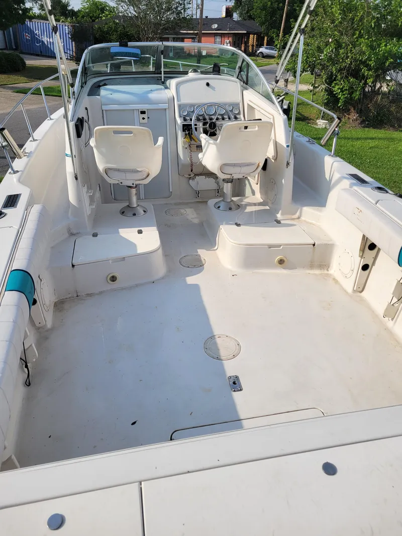 Slide: The Image of 1996 Pro-Line 231 Walk Around Cuddy boat interior with seating and controls. - 8
