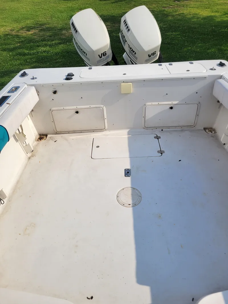 Slide: The Image of 1996 Pro-Line 231 Walk Around Cuddy boat with twin V6 engines. - 9