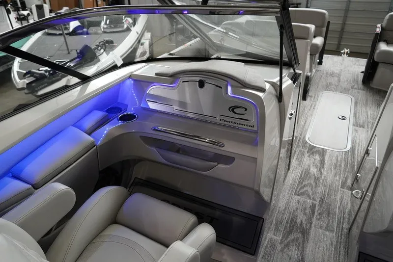 Slide: The Image of 2024 Crest Continental 250 SLS CP3 boat interior with modern seating and blue LED lighting. - 11