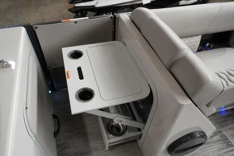 Slide: The Image of 2024 Crest Continental 250 SLS CP3 boat interior with foldable table and cup holders. - 14