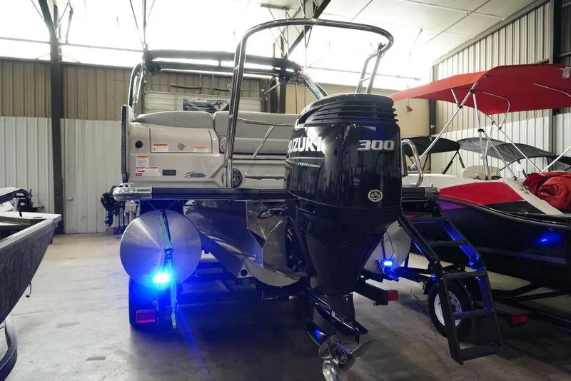 Slide: The Image of 2024 Crest Continental 250 SLS CP3 boat with 300 hp Suzuki engine in a showroom. - 18