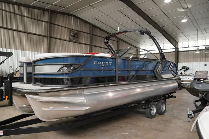 Slide: The Image of 2024 Crest Continental 250 SLS CP3 pontoon boat in a warehouse. - 20