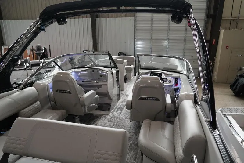 Slide: The Image of 2024 Crest Continental 250 SLS CP3 boat interior with luxurious seating and modern dashboard. - 21