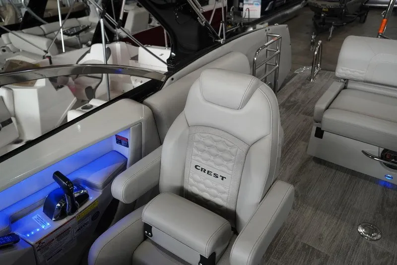 Slide: The Image of 2024 Crest Continental 250 SLS CP3 boat interior with captain's chair and control panel. - 9