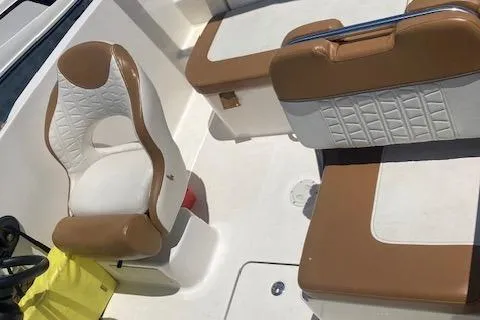 Slide: The Image of 2021 Bayliner VR5 boat interior with white and brown seating. - 2