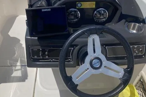 Slide: The Image of 2021 Bayliner VR5 boat dashboard with steering wheel and Simrad display. - 4