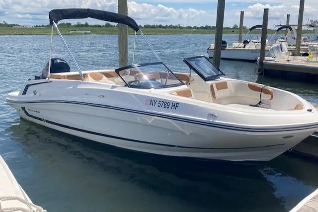 Slide: The Image of 2021 Bayliner VR5 boat docked in a marina on a sunny day. - 7