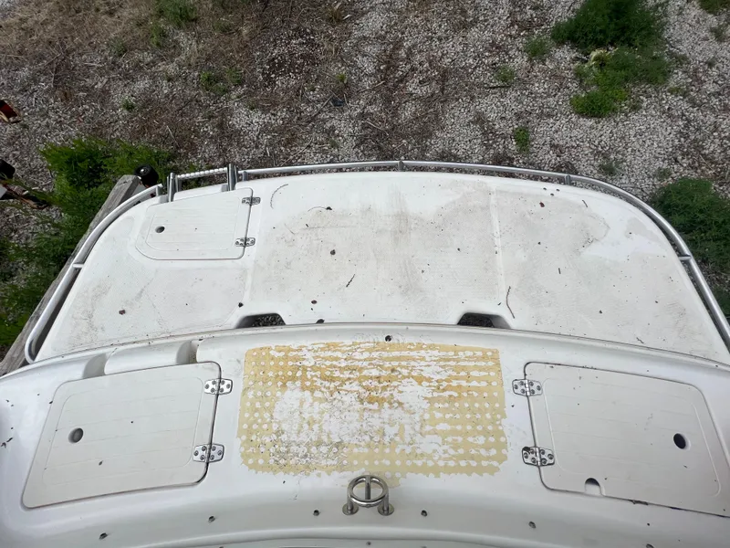 Slide: The Image of Top view of a 2004 Bryant 234 boat deck with wear and tear. - 11