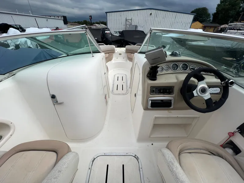 Slide: The Image of 2004 Bryant 234 boat interior with steering wheel and dashboard. - 7