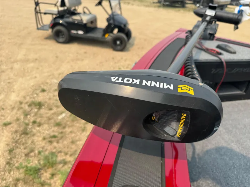 Slide: The Image of Minn Kota motor on 2023 Tracker Targa V-18 WT boat, with golf cart in background. - 12