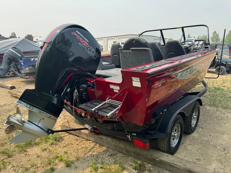 Slide: The Image of 2023 Tracker Targa V-18 WT boat with powerful outboard motor, parked on a trailer. - 3