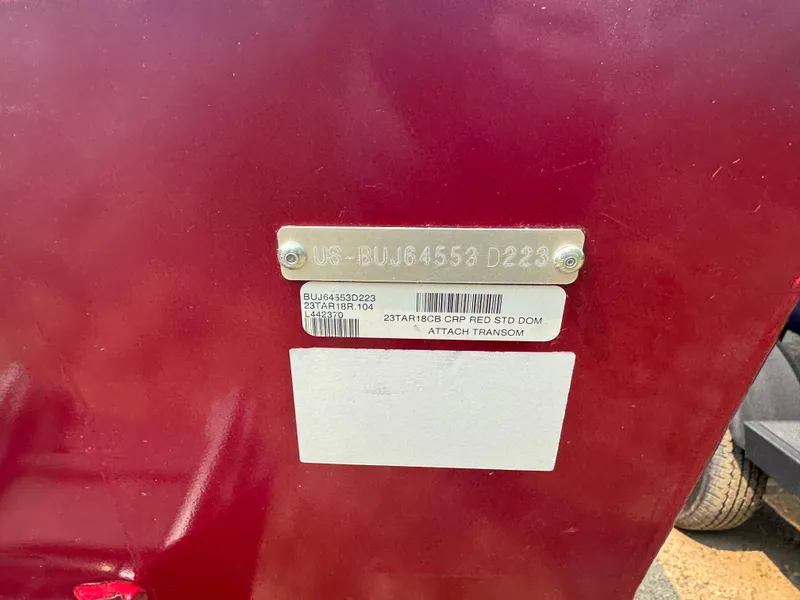 Slide: The Image of 2023 Tracker Targa V-18 WT boat identification plate on a red surface. - 4